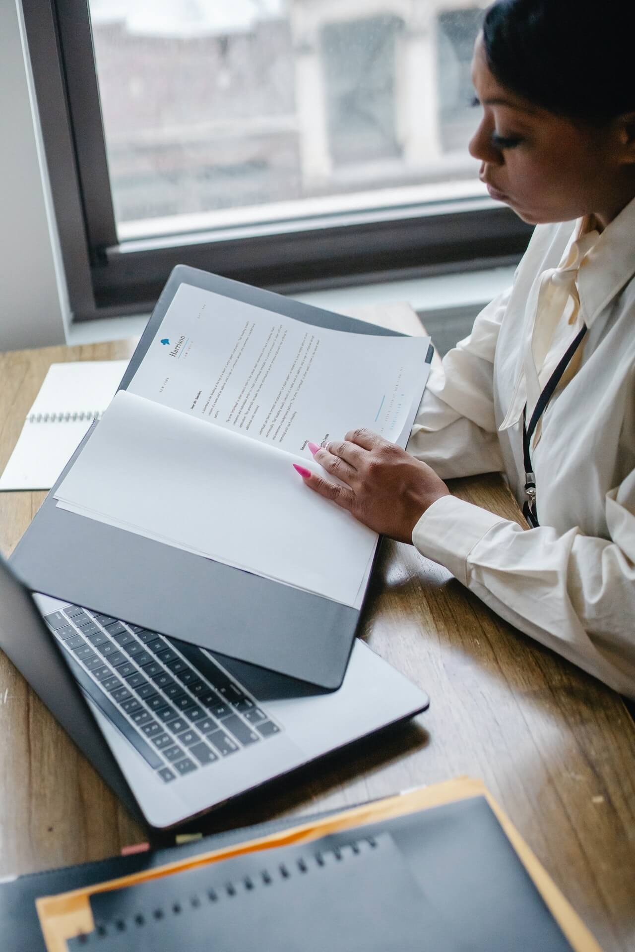Person reading documents at a desk